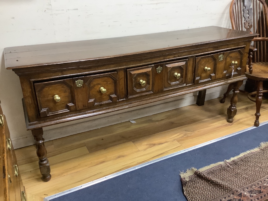 A Charles II oak dresser, fitted three drawers, with geometric mounted fronts